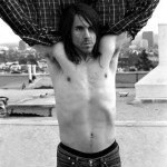 Anthony Kiedis black & white photo of him with shirt held up over head