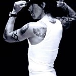 Anthony Kiedis black & white photo of him sideways in white t-shirt with a black hat