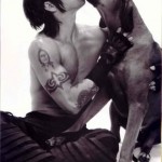 Anthony Kiedis black & white photo of him kissing a dog