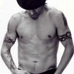 Anthony Kiedis black & white topless lookng down at belt