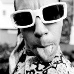 Anthony Kiedis wearing shades & sticking out tongue black & white photo