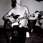 Anthony Kiedis black & white photo of him playing a guitar