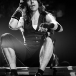 Anthony Kiedis black & white photo of him sitting on stage