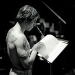 Anthony Kiedis black & white photo of him reading a music score