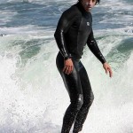 anthony kiedis standing on surfboard ocean