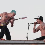 bare chested anthony Kiedis baseball cap singing on rooftop with RHCP in Muscle Beach California