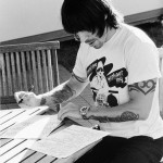 Anthony Kiedis writing at a desk black & white photo