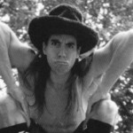 Anthony Kiedis black & whitephoto of him wearing a hat and pointing downwards
