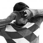 Anthony Kiedis wearing a diamond jumper sweater taking a photo black & white