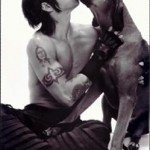 Anthony Kiedis with a pig snout and a dog