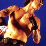 Anthony Kiedis topless against a blue background
