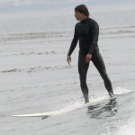 anthony kiedis standing on surfboard ocean