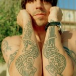 Anthony Kiedis forearm tattoos of a pair of celtic tribal daggers