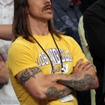 Anthony Kiedis Lakers game LA arms crossed in yellow t-shirt