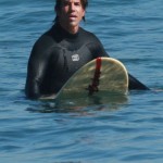 anthony kiedis sitting on surfboard ocean