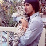 Anthony Kiedis cuddling a white tiger cub