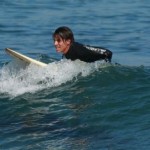 anthony kiedis sitting on surfboard sea
