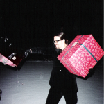 Photo taken by Blackie Dammett of Anthony Kiedis at Christmas with huge present