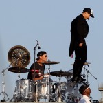 anthony Kiedis standing on drum kit singing on rooftop with RHCP in Muscle Beach California